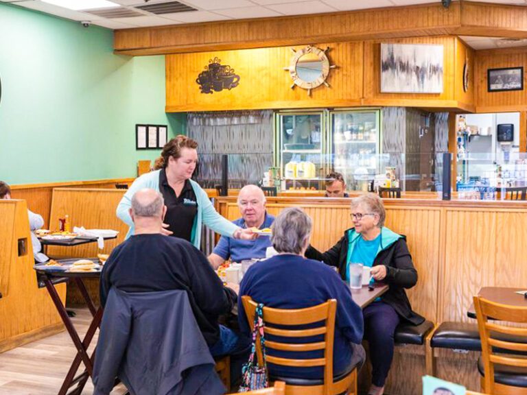 Pancake franchise customers seated at table